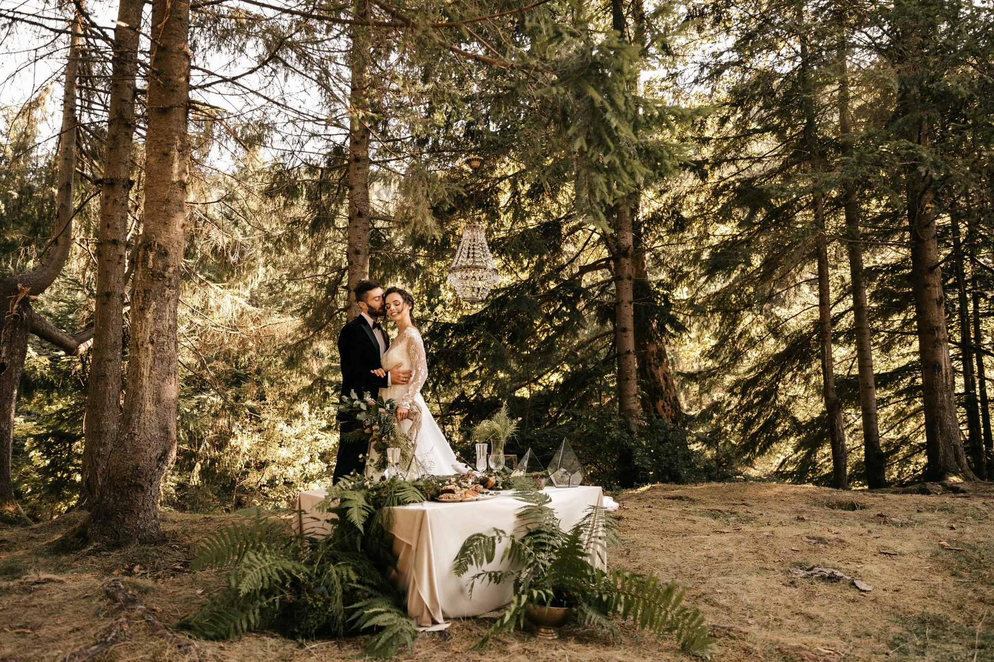 Newlyweds hugging in a forest setting