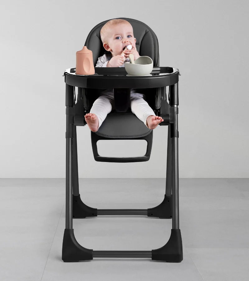 Cute baby sitting in high chair