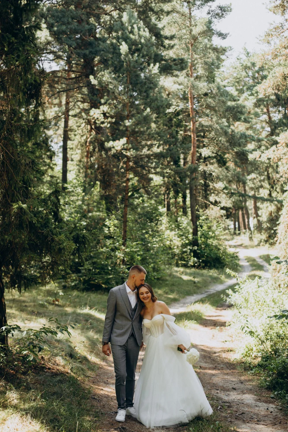 Married couple walking through woods