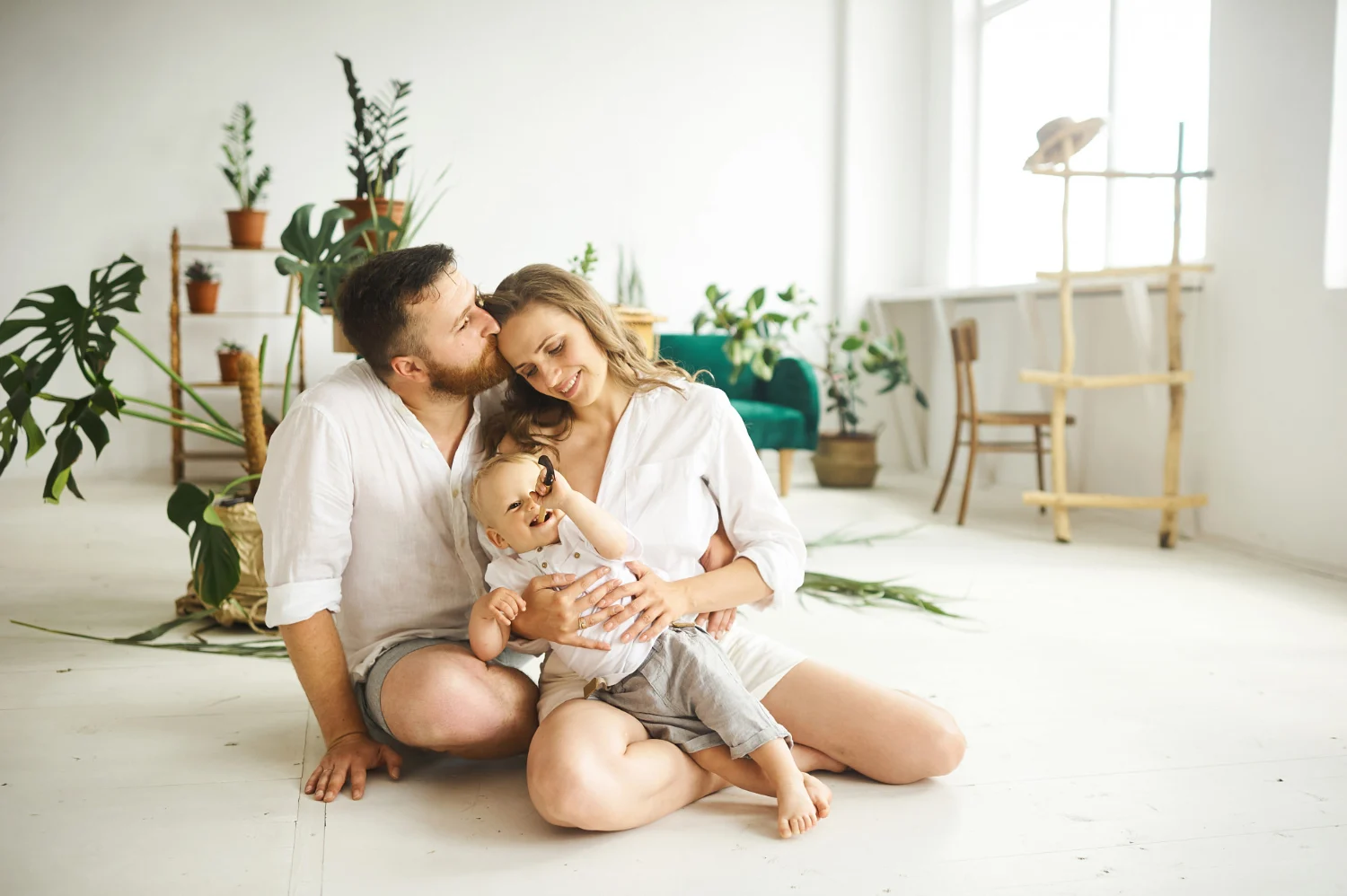 Happy couple with baby in living room