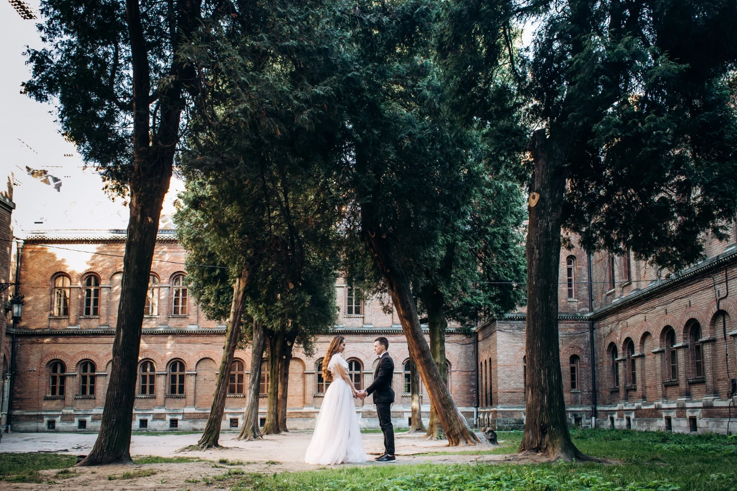 Bride and groom posing outside elegant wedding venue