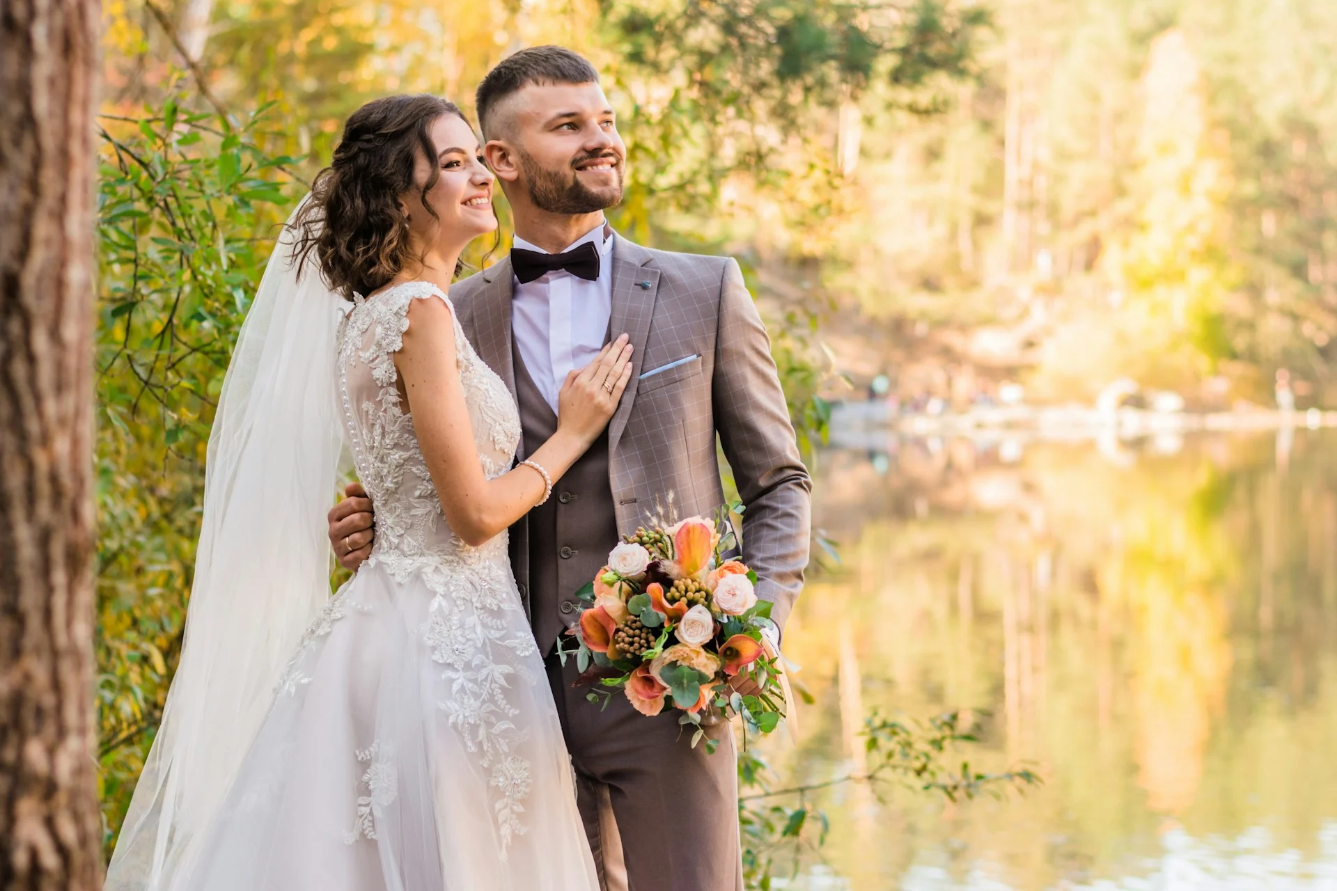 Elegant bride and groom outside lake wedding photo