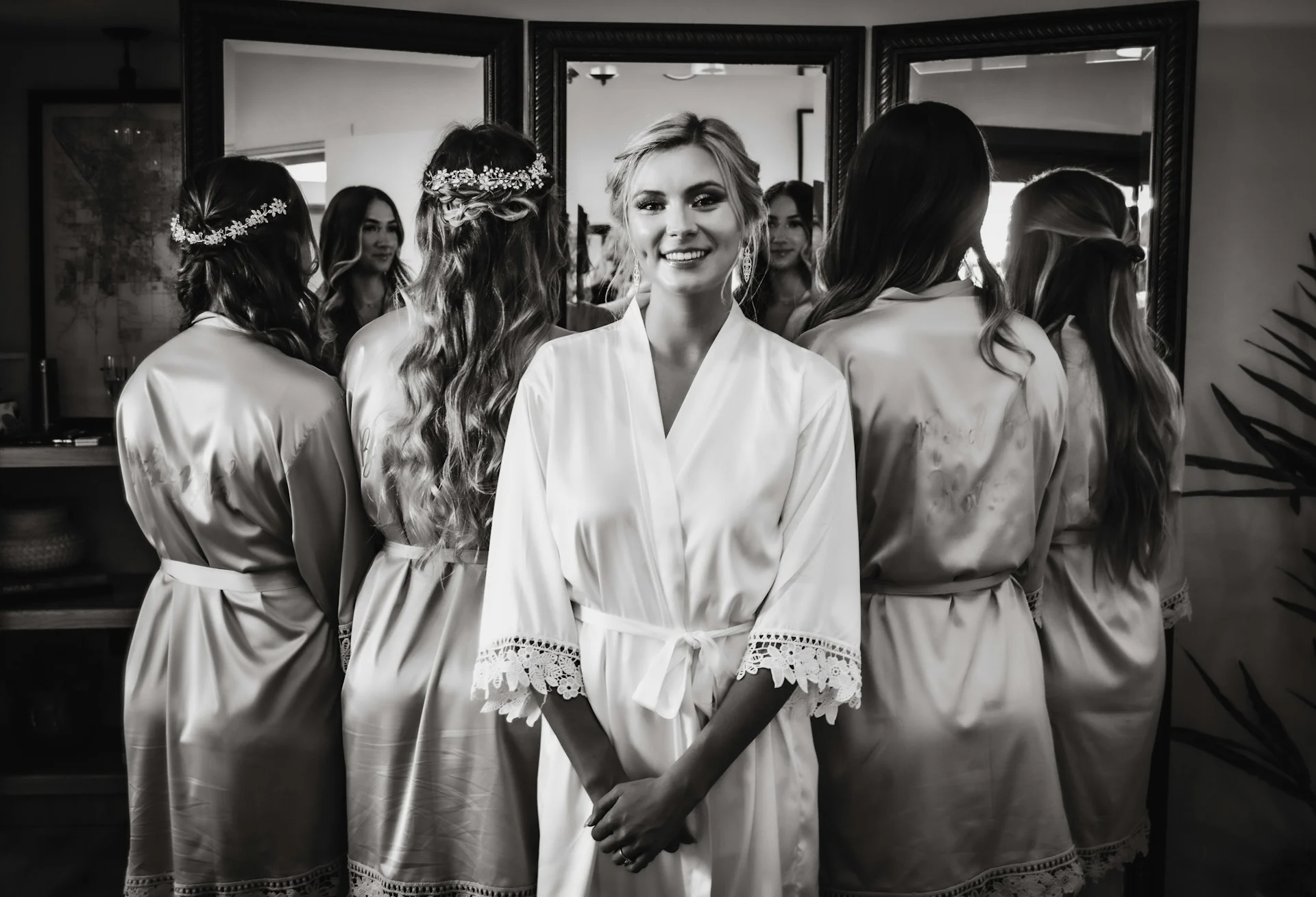 Bride getting ready for wedding alongside bridesmaids