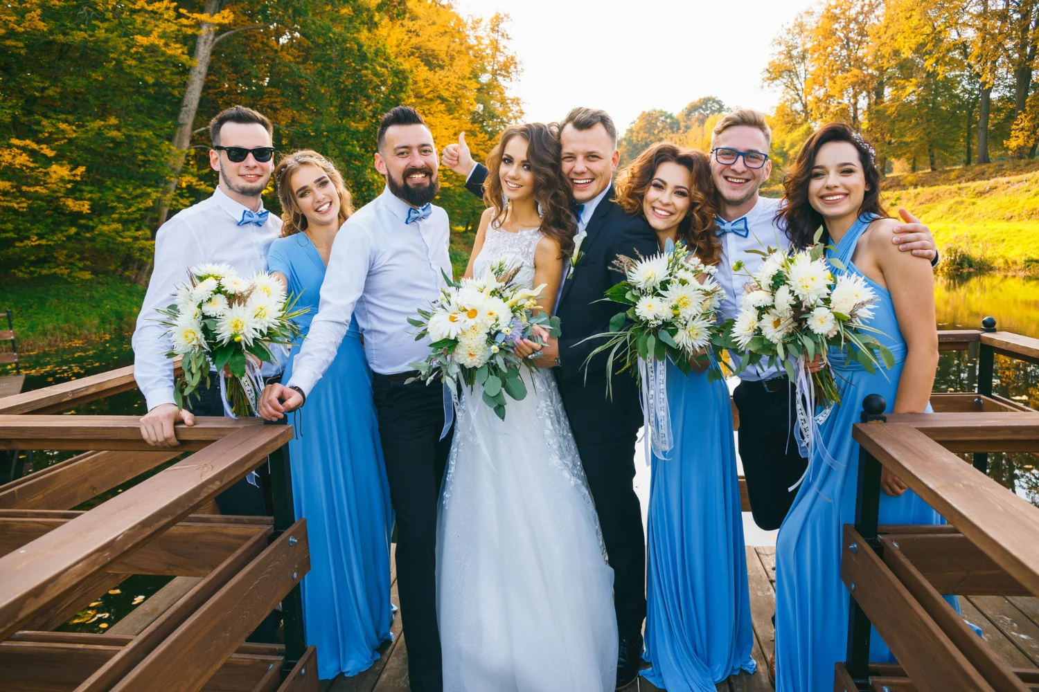 Newly married couple with groomsmen and bridesmaids taking photos