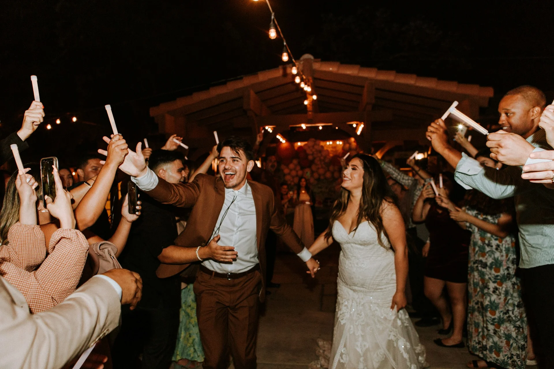 Man and woman outdoors celebrating wedding with family