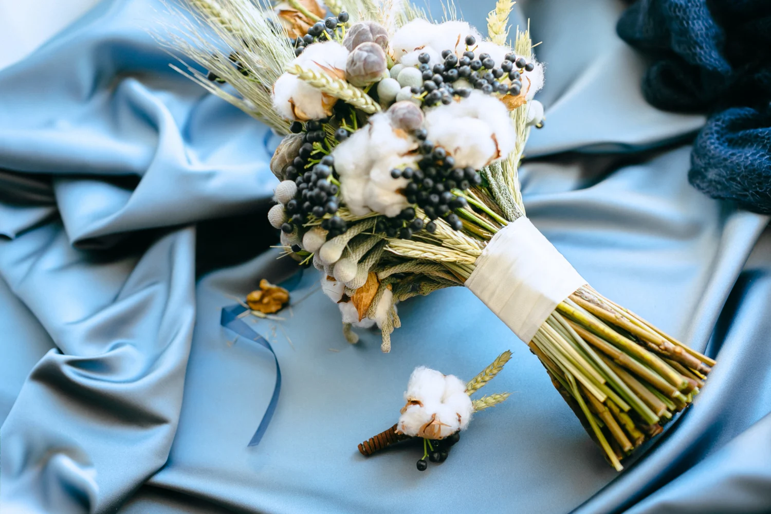 Wedding flower decorations on a dusty blue table cloth